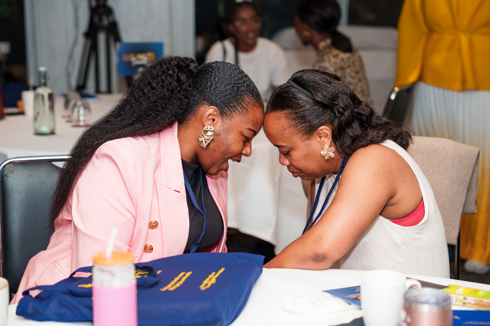 Two women praying together at a Christian in Corporate gathering